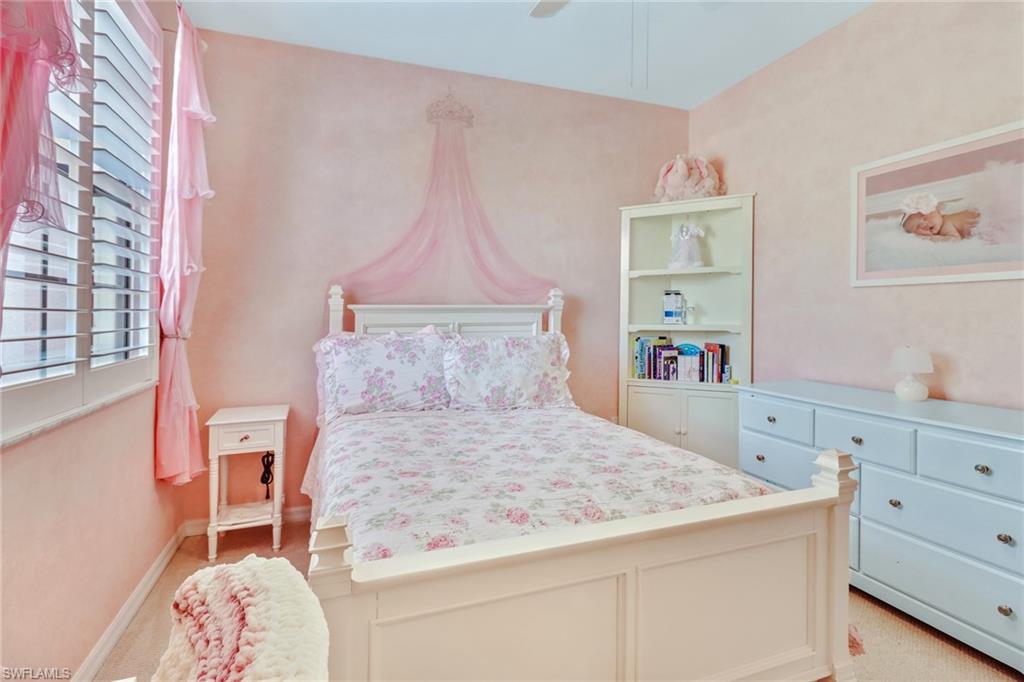 15663 Summit Pl Circle, Unit 328 Naples, FL 34119 - Photo 16 of 32 a bedroom with a bed and a window
