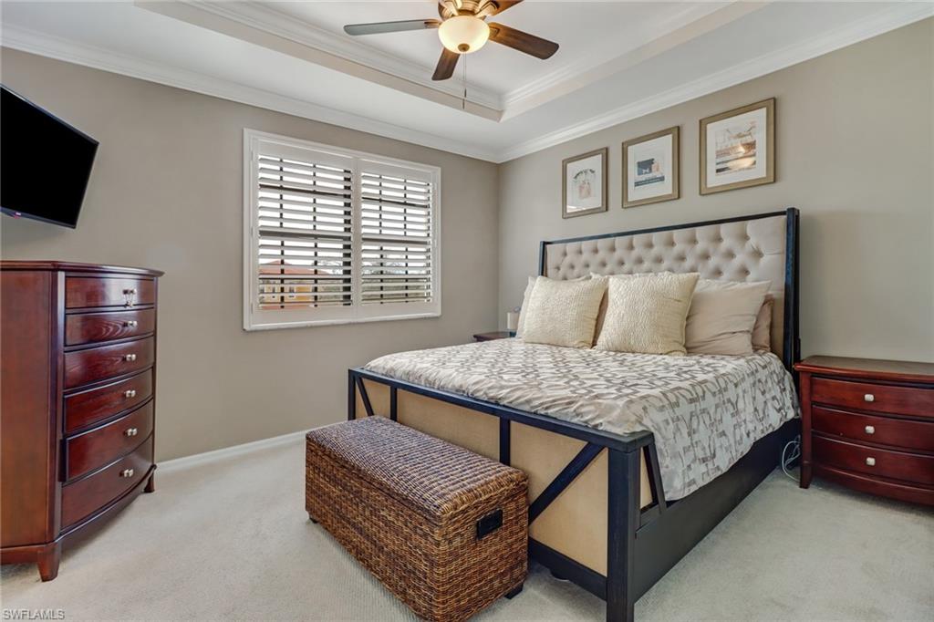 15663 Summit Pl Circle, Unit 328 Naples, FL 34119 - Photo 17 of 32 a bedroom with a bed and a flat screen tv