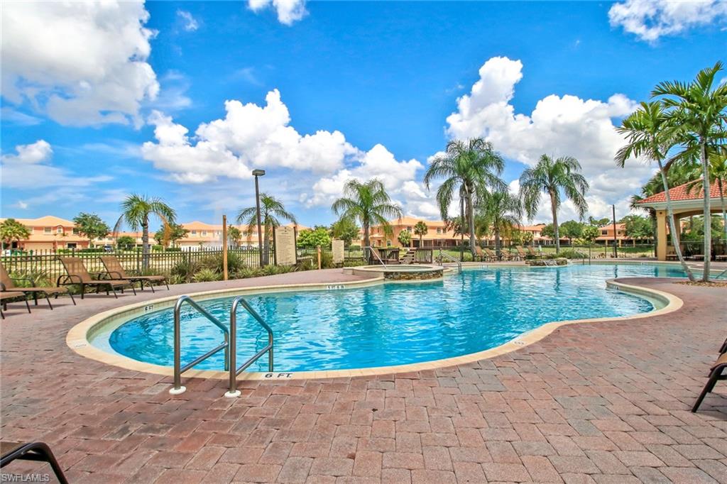 15663 Summit Pl Circle, Unit 328 Naples, FL 34119 - Photo 31 of 32 a view of a swimming pool with outdoor seating