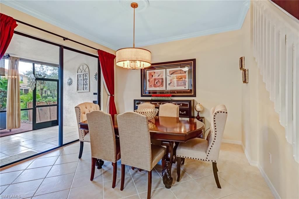 15663 Summit Pl Circle, Unit 328 Naples, FL 34119 - Photo 7 of 32 a dining room with furniture a chandelier and window