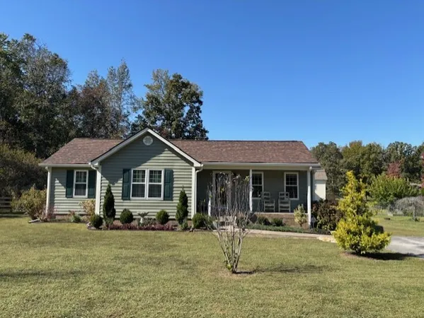 a front view of a house with a yard patio and fire pit