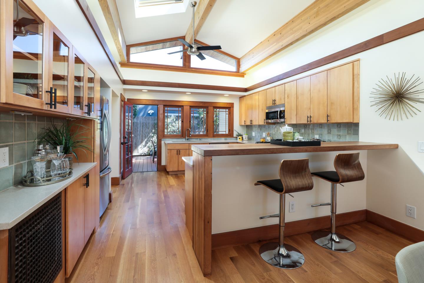 155 Alice Avenue Campbell, CA 95008 - Photo 11 of 36 a kitchen with stainless steel appliances a stove a sink dishwasher and a dining table with wooden floor