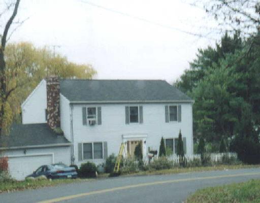 a view of a house with a yard and garage