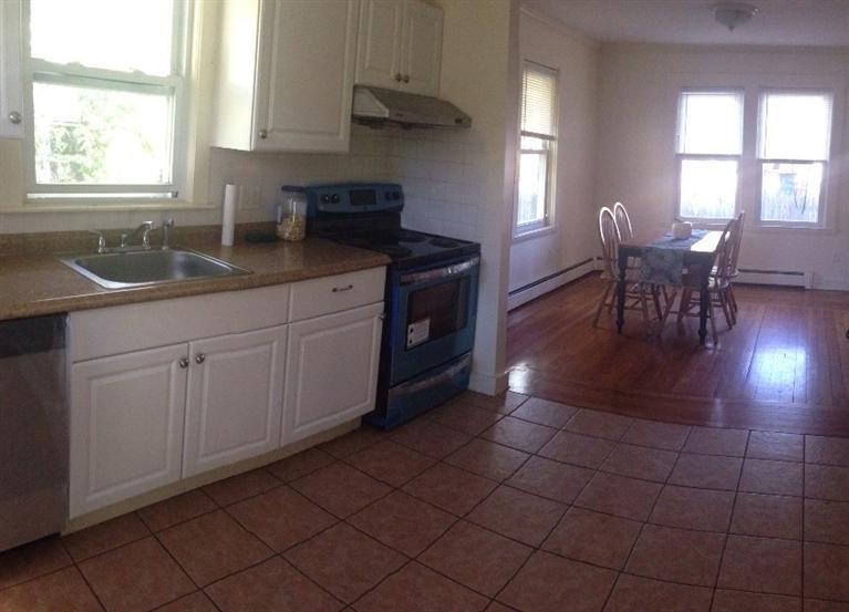 16 Chestnut Street Hyannis, MA 02601 - Photo 4 of 11 a kitchen with a sink cabinets and window