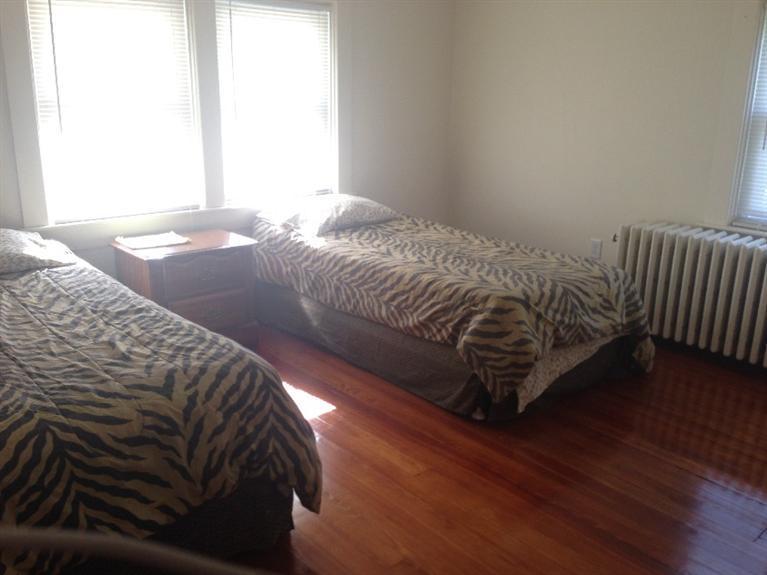 16 Chestnut Street Hyannis, MA 02601 - Photo 9 of 11 a bed sitting in a bedroom next to a window