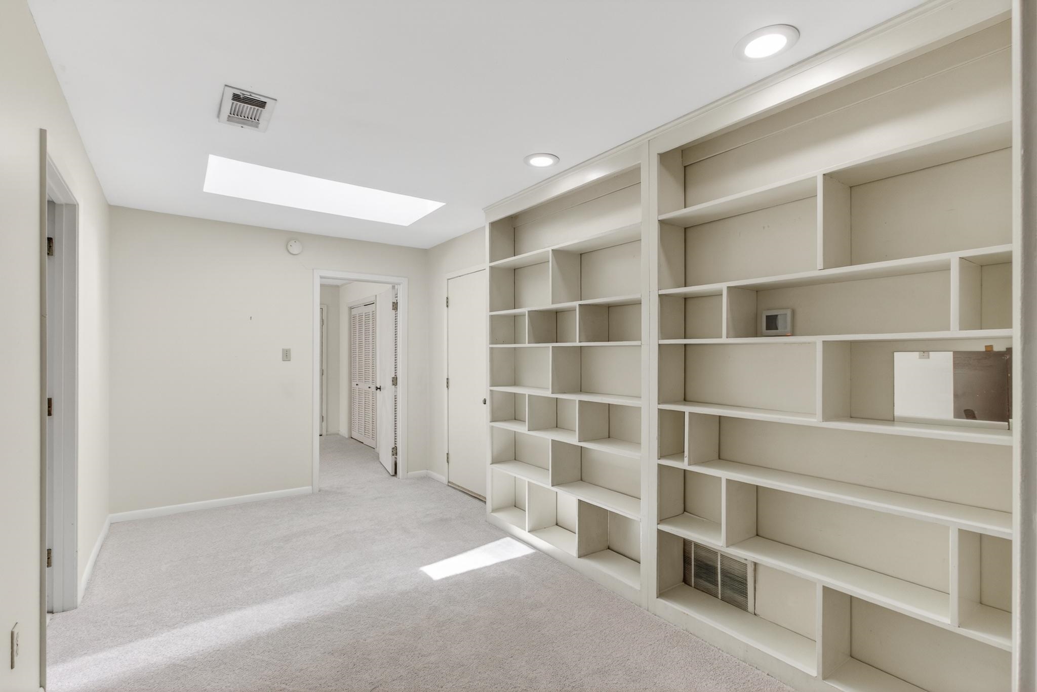 3121 Beechrun Drive Memphis, TN 38128 - Photo 28 of 40 The loft space features a wall of custom built-ins, and plenty of space for children to have a play area or a reading room! Walk-in attic space can be accessed from this room as well as the full bathroom upstairs.