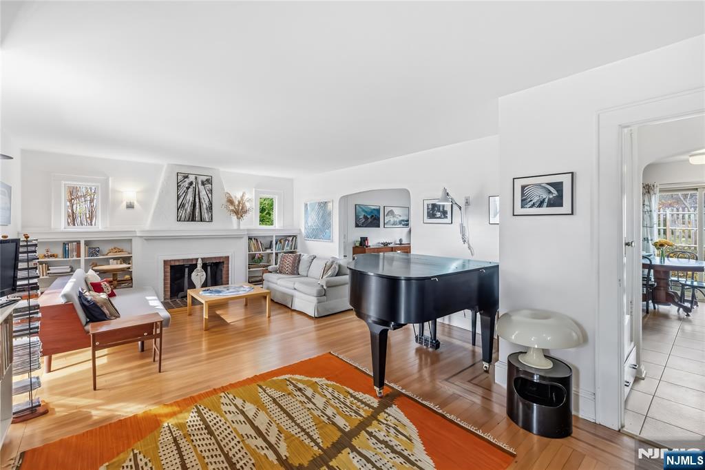 69 Sussex Road Tenafly, NJ 07670 - Photo 12 of 39 a living room with furniture a fireplace and a table
