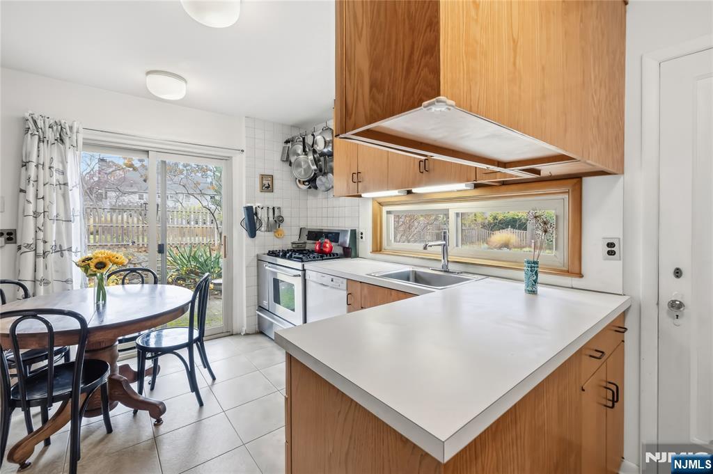 69 Sussex Road Tenafly, NJ 07670 - Photo 20 of 39 a kitchen with a table chairs and a window