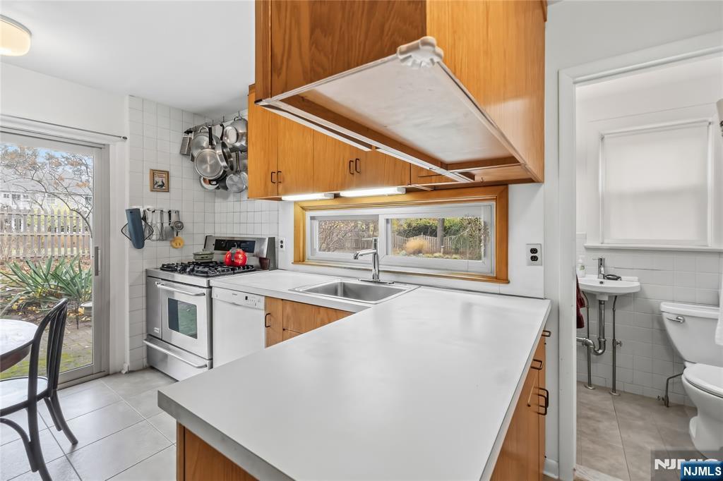 69 Sussex Road Tenafly, NJ 07670 - Photo 22 of 39 a kitchen with a stove a sink and a refrigerator