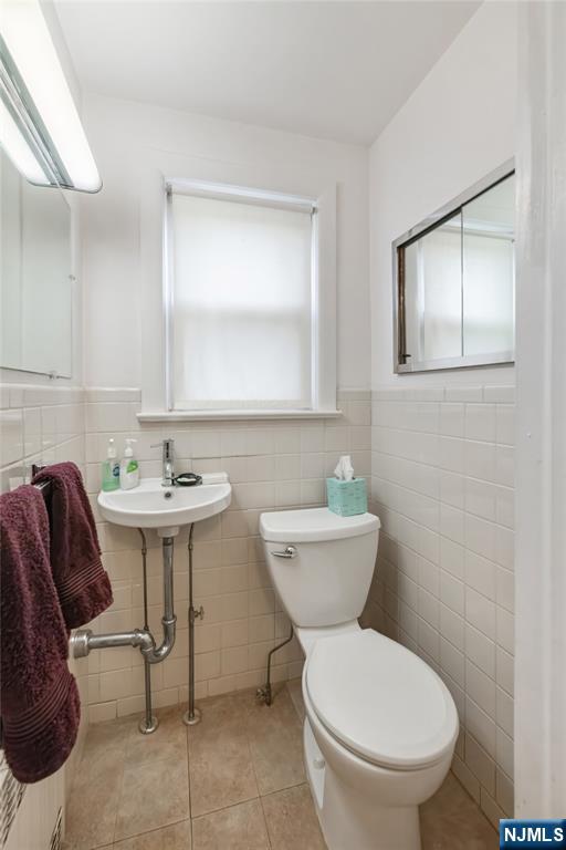 69 Sussex Road Tenafly, NJ 07670 - Photo 23 of 39 a bathroom with a toilet sink and mirror