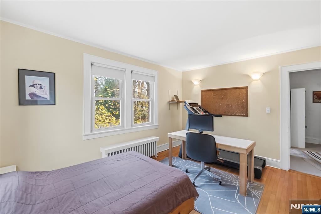 69 Sussex Road Tenafly, NJ 07670 - Photo 31 of 39 a bedroom with a bed and wooden floor