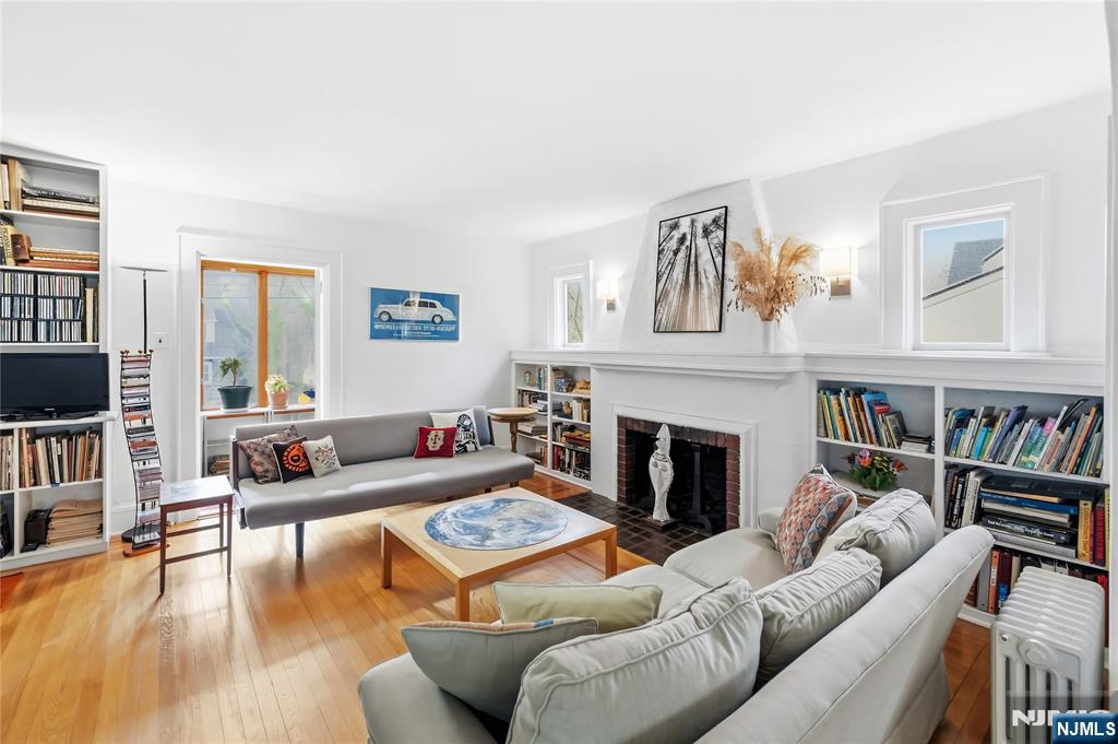 69 Sussex Road Tenafly, NJ 07670 - Photo 9 of 39 a living room with furniture and a fireplace