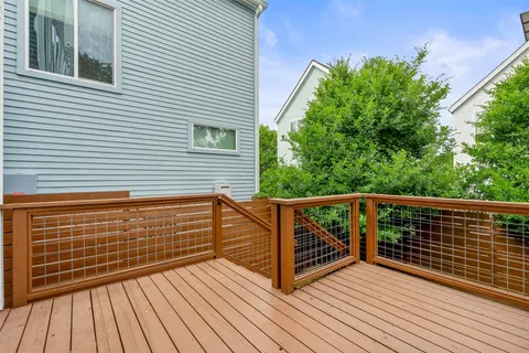 a view of deck with a flat tv screen and wooden floor