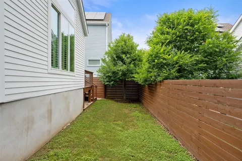 a view of a backyard with chairs