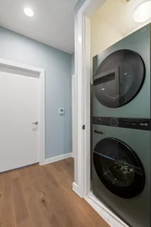a living room with a fireplace and a washer