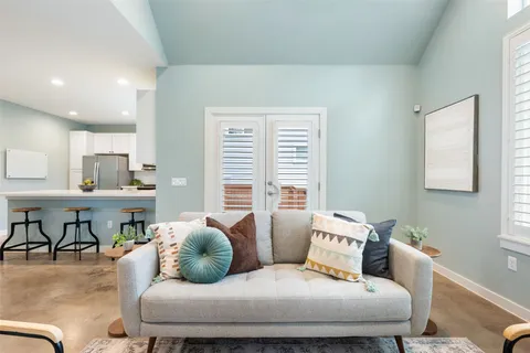 a living room with furniture and a large window