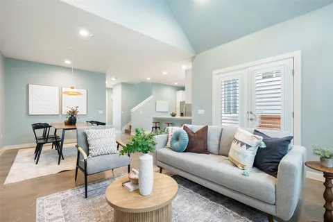 a living room with furniture and a potted plant