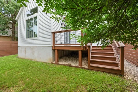 a view of a house with backyard and a tree