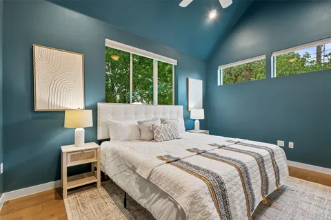 a bedroom with a bed and a lamp on table