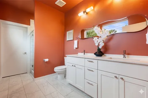 a bathroom with a double vanity sink and a mirror
