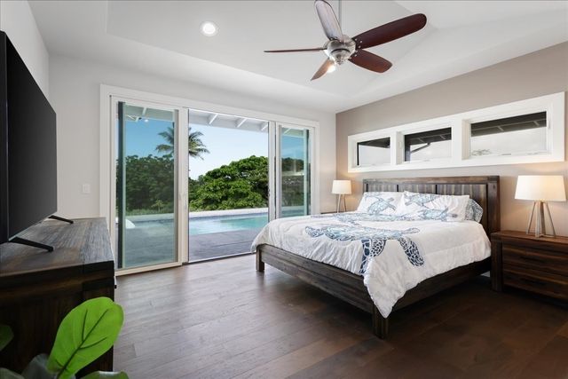 a bedroom with bed and flat screen tv