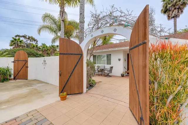 a view of a patio with table and chairs and potted plants