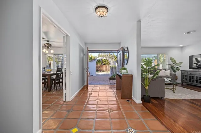 a living room with furniture hard wood floor and a flat screen tv