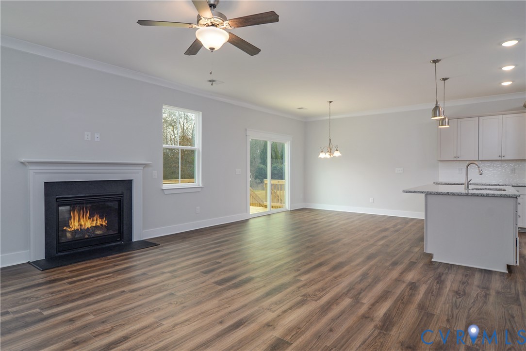 2004 Swiss Lane Hayes, VA 23072 - Photo 2 of 10 a view of empty room with wooden floor and fireplace