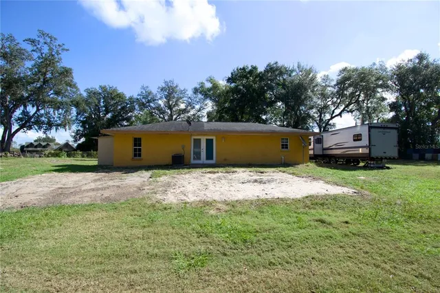 a front view of house with yard and trees
