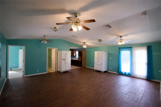 a view of a livingroom with a ceiling fan and window