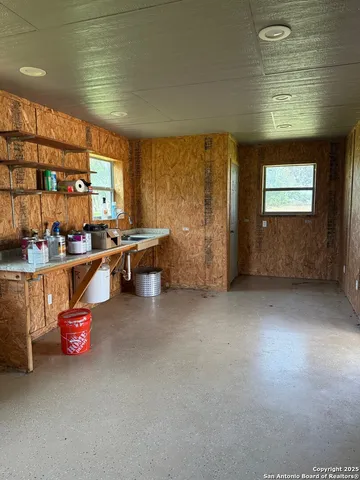a room with pool table and window
