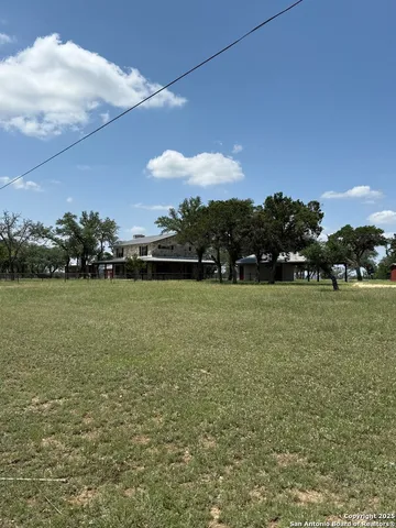 a view of yard with swimming pool and green space