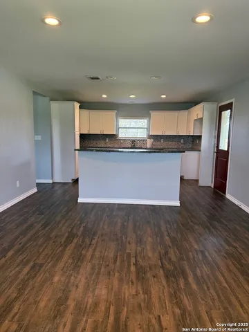 a view of kitchen and hall with wooden floor