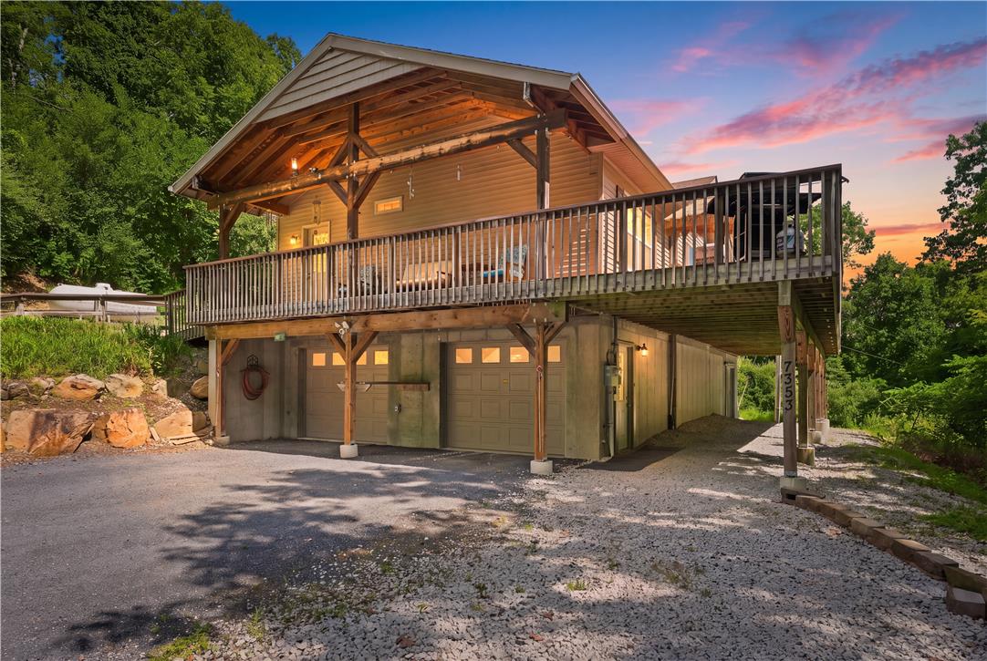 7353 Farrier Road Orefield, PA 18069 - Photo 6 of 74 Substantial timber framing and a spacious elevated deck define this distinctive rustic exterior design.