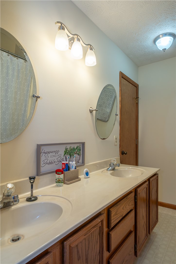3628 Petre Road Springfield, OH 45502 - Photo 21 of 52 This bathroom features a double vanity with two sinks and practical storage below.