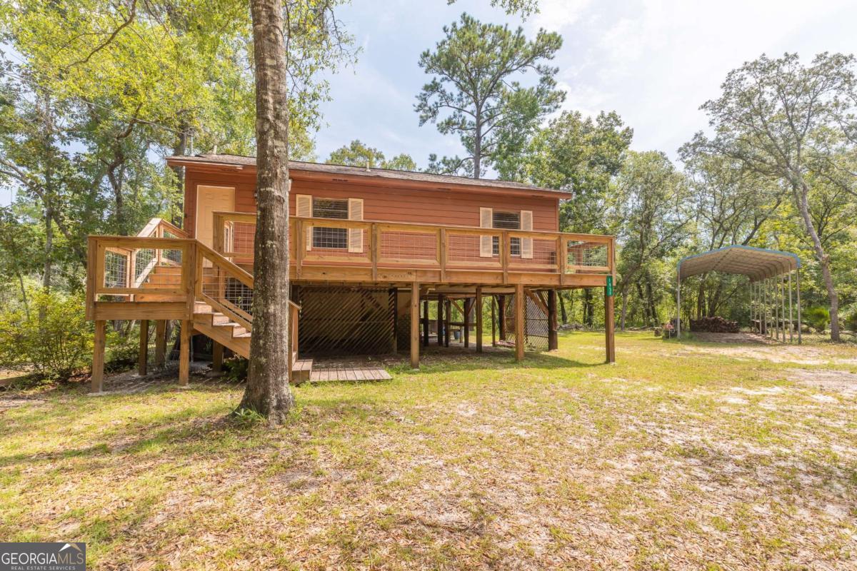 1656-t O To Jones Road Reidsville, GA 30453 - Photo 1 of 22 a view of a house with backyard and a tree