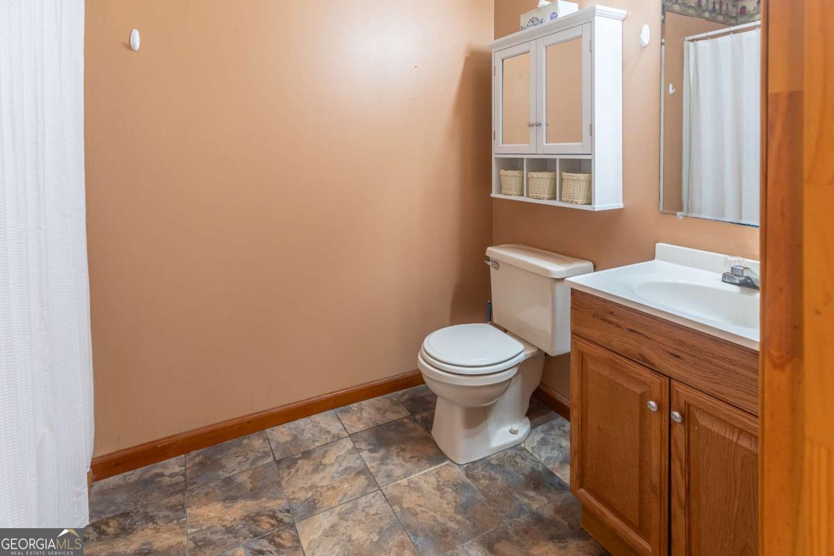 1656-t O To Jones Road Reidsville, GA 30453 - Photo 17 of 22 a white toilet sitting next to a bathroom sink