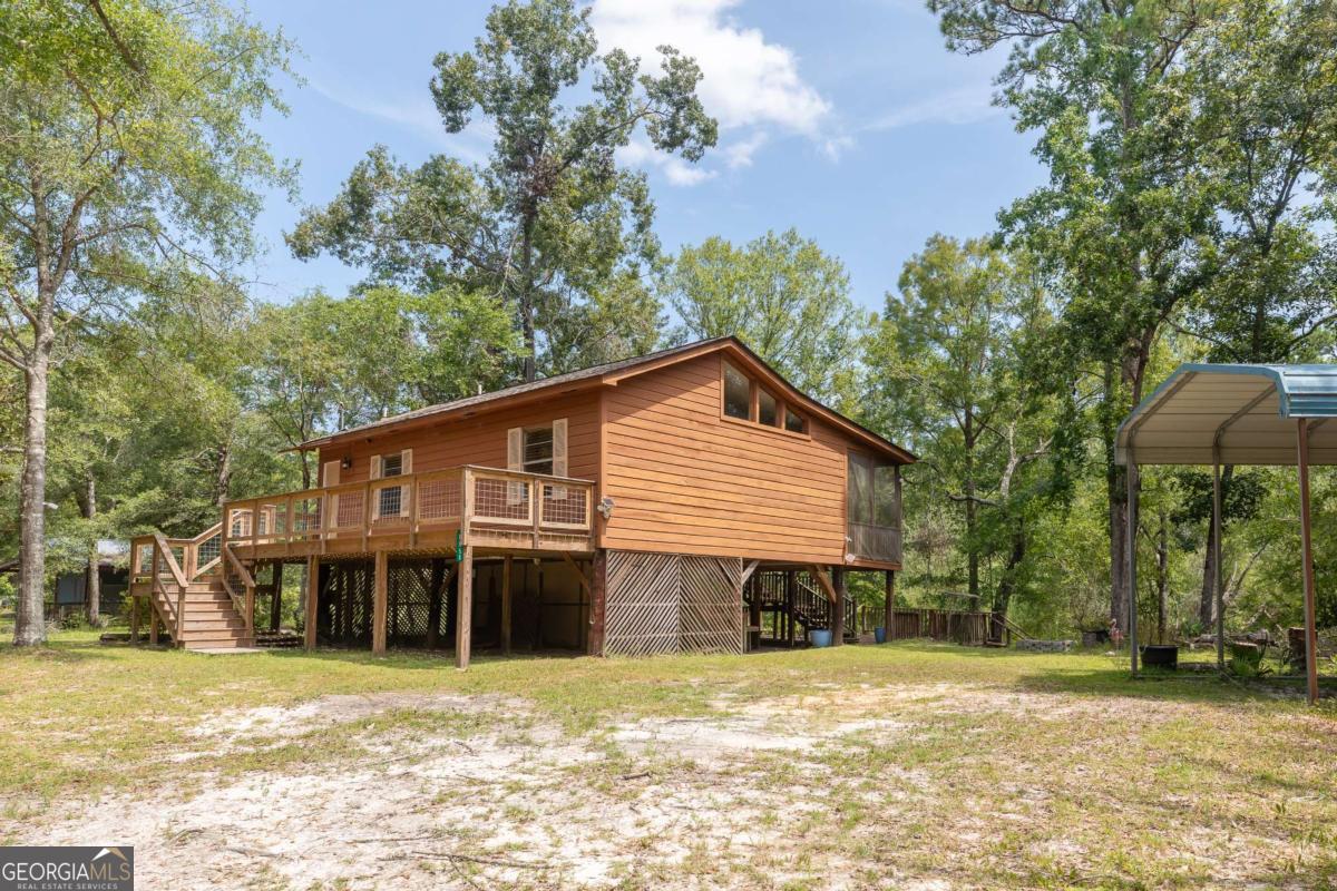 1656-t O To Jones Road Reidsville, GA 30453 - Photo 2 of 22 a view of a house with a backyard and trees