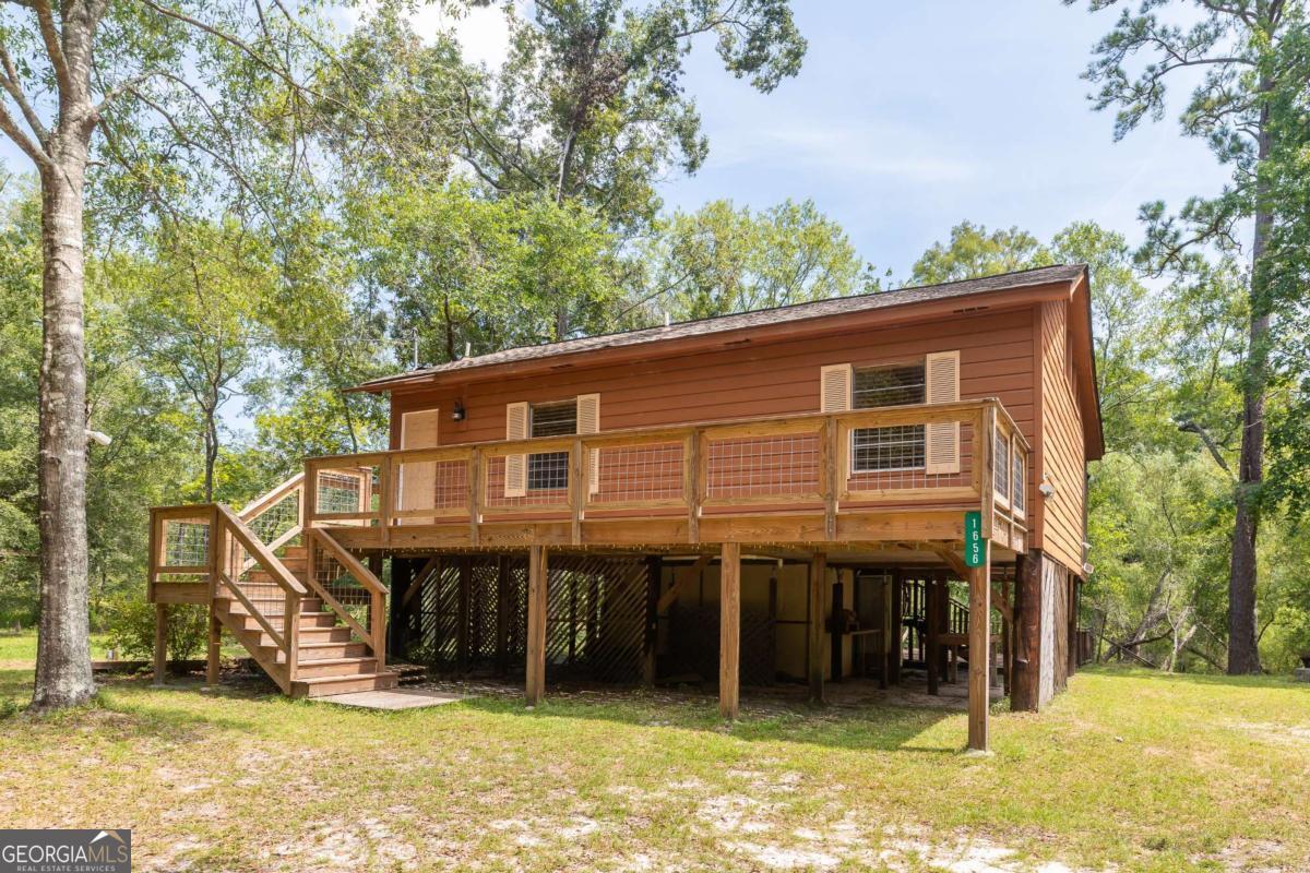 1656-t O To Jones Road Reidsville, GA 30453 - Photo 3 of 22 a backyard of a house with table and chairs