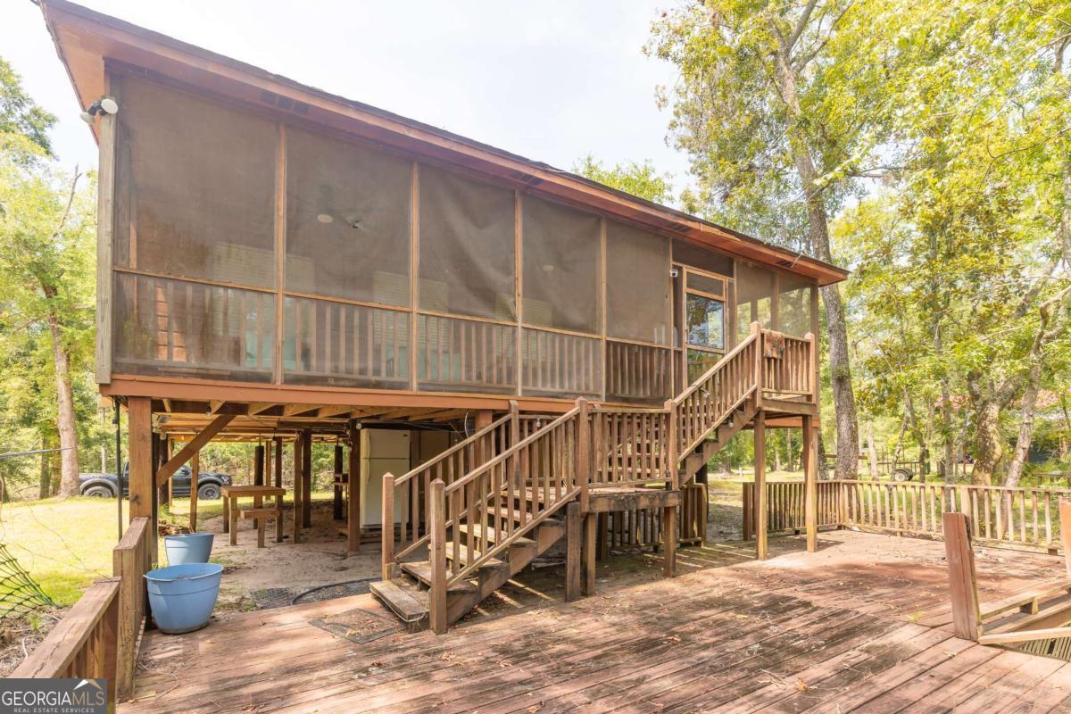 1656-t O To Jones Road Reidsville, GA 30453 - Photo 5 of 22 a roof deck with table and chairs and wooden floor