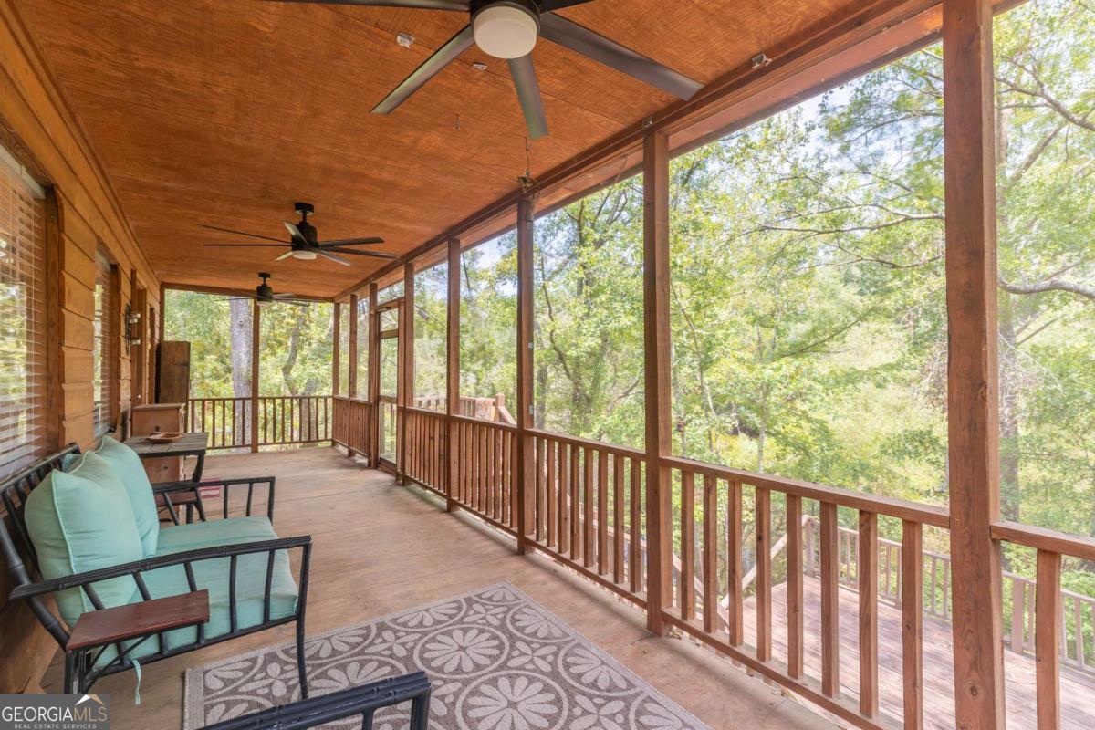 1656-t O To Jones Road Reidsville, GA 30453 - Photo 7 of 22 a living room with furniture and a floor to ceiling window