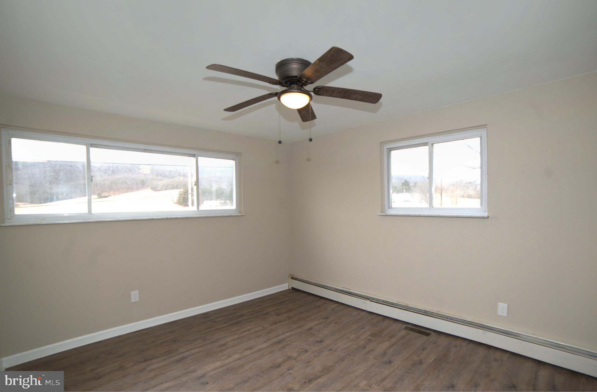 2226 Hyndman Road Hyndman, PA 15545 - Photo 12 of 15 a view of an empty room with wooden floor and a window