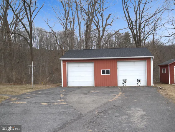 a view of a house with a outdoor space and tree