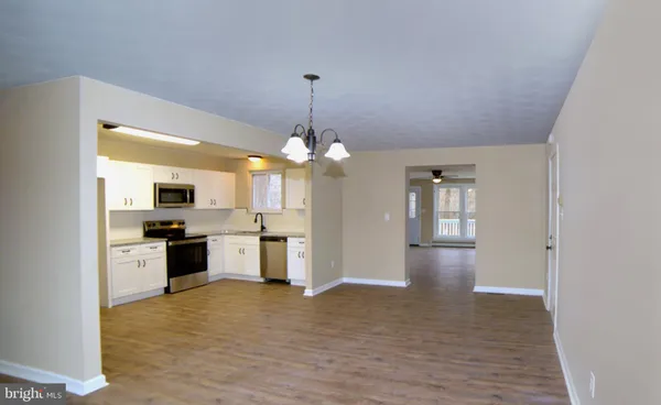 a view of a kitchen with a stove cabinets and wooden floor