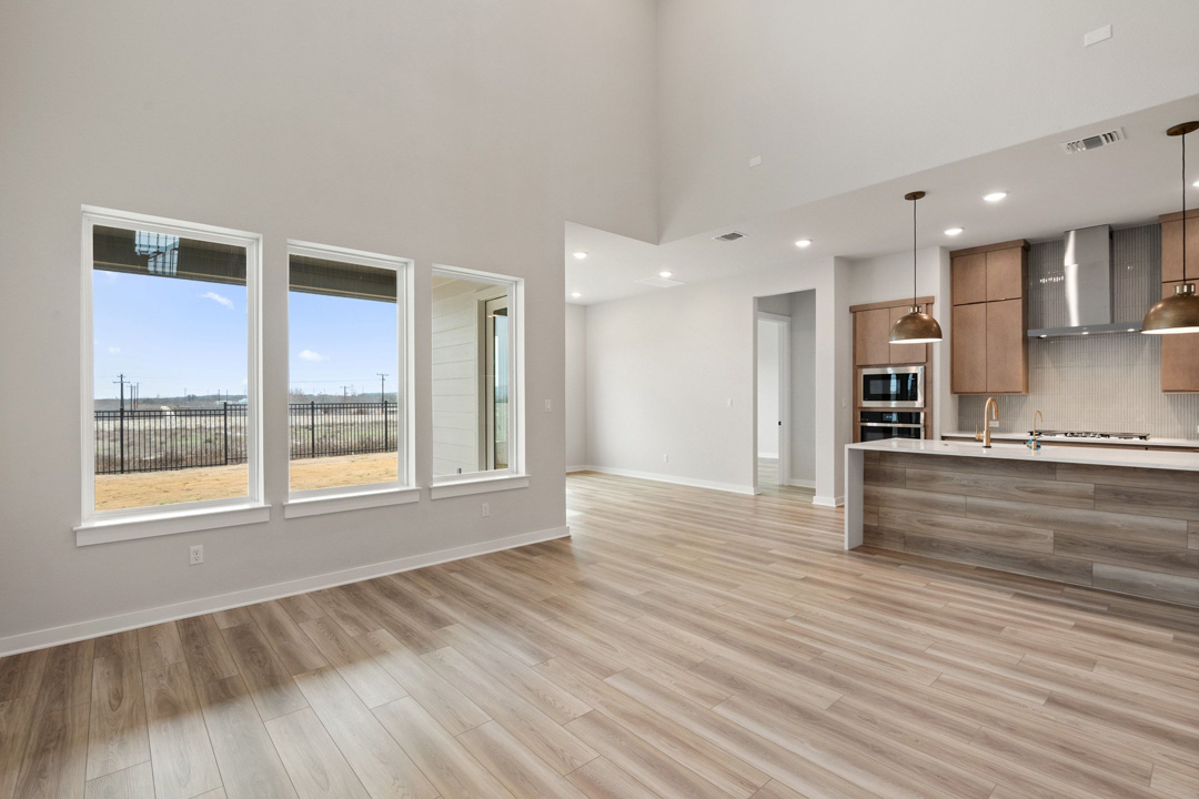 16209 Smithers Road Manor, TX 78653 - Photo 12 of 38 a view of an empty room with a window and wooden floor