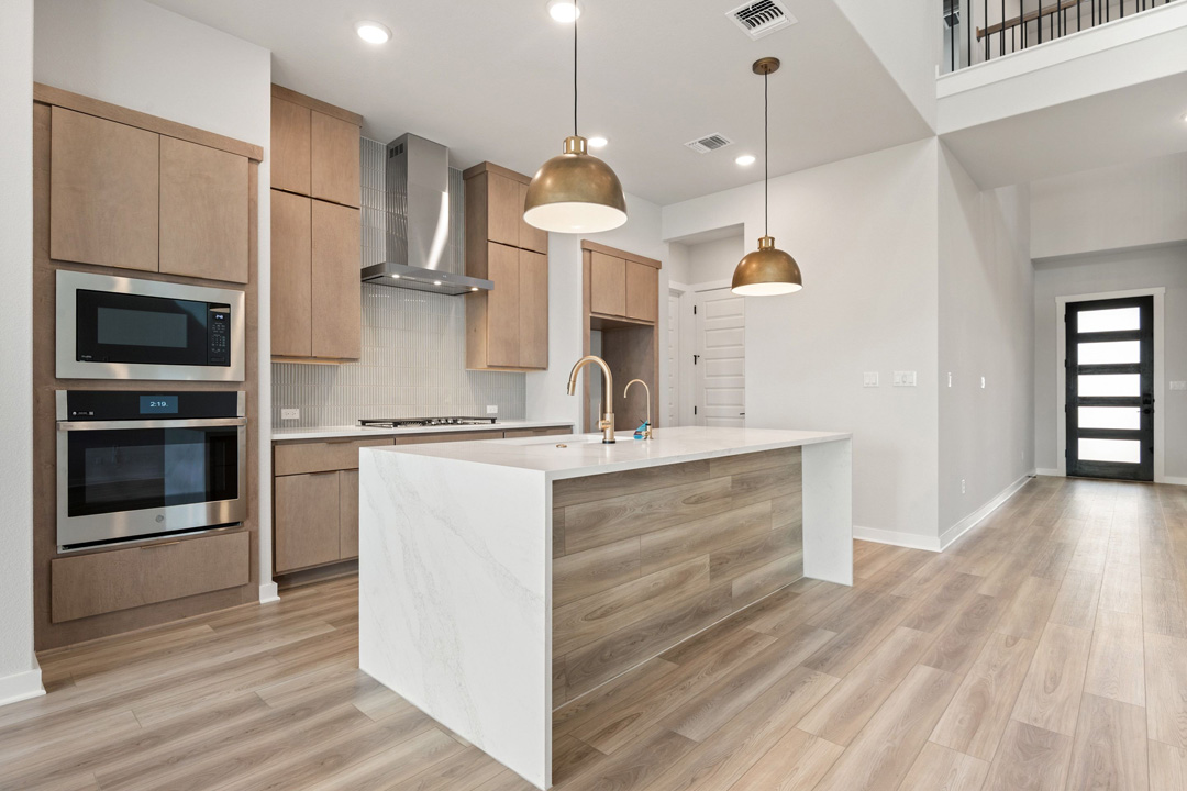 16209 Smithers Road Manor, TX 78653 - Photo 16 of 38 a kitchen with kitchen island a sink stainless steel appliances and cabinets