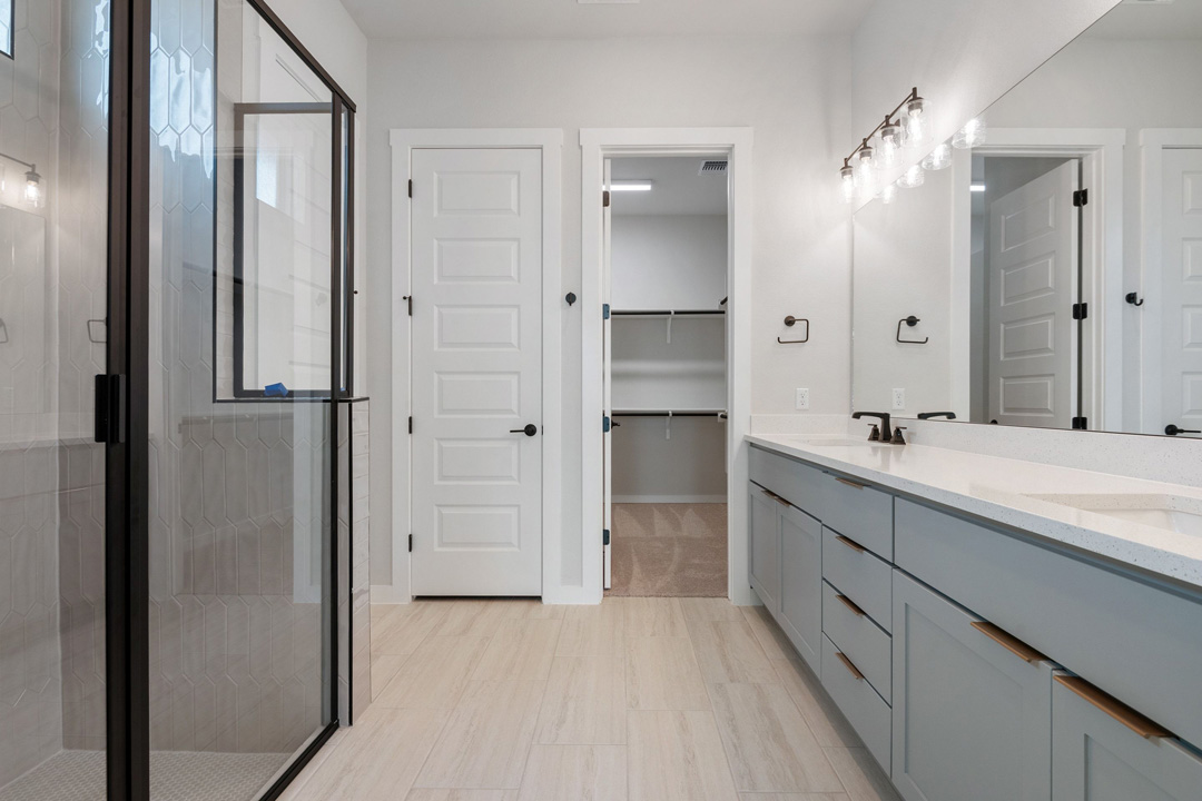 16209 Smithers Road Manor, TX 78653 - Photo 20 of 38 a spacious bathroom with a shower a sink and a mirror