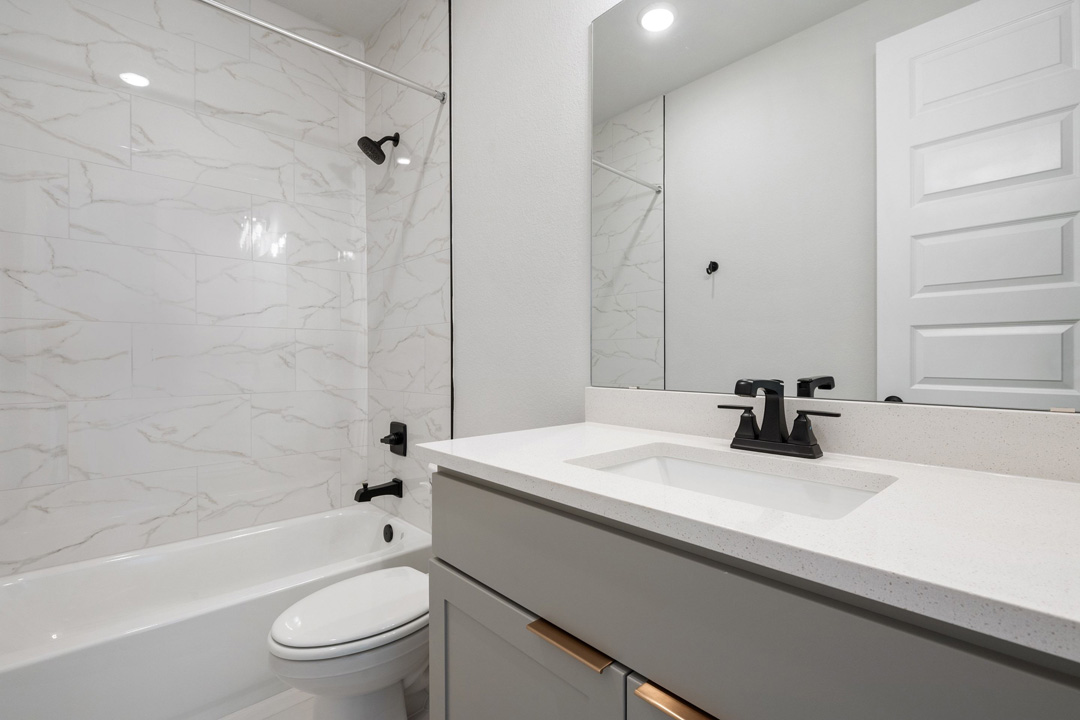 16209 Smithers Road Manor, TX 78653 - Photo 24 of 38 a bathroom with a sink a toilet and a bathtub