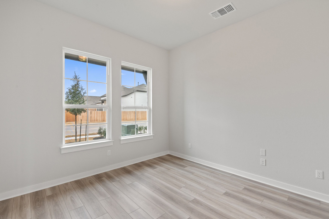 16209 Smithers Road Manor, TX 78653 - Photo 5 of 38 an empty room with wooden floor and windows