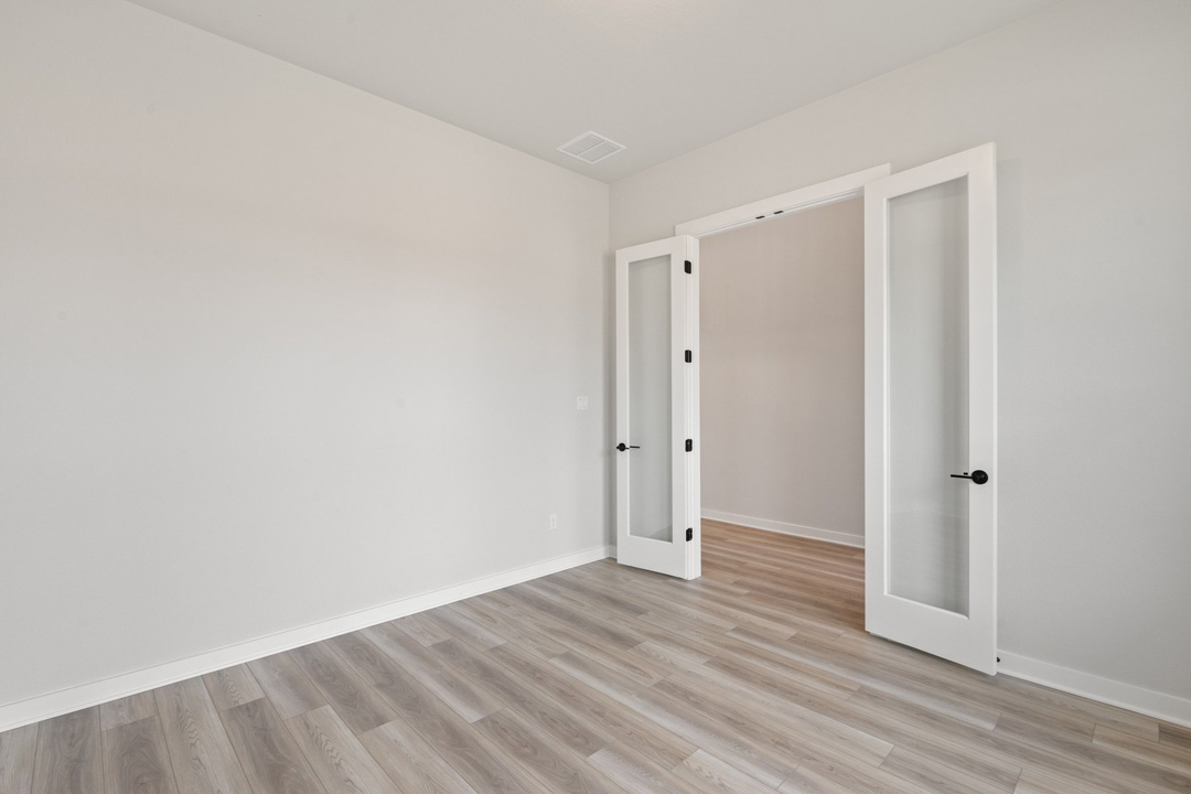 16209 Smithers Road Manor, TX 78653 - Photo 6 of 38 a view of an empty room with wooden floor and closet